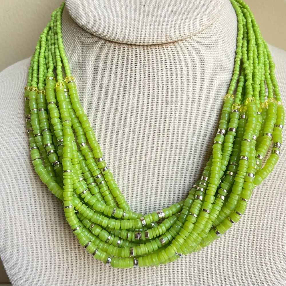 Green multistrand seed bead necklace with bright silvertone accents and finials